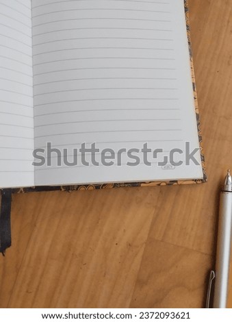 daily activity notebook along with pens for design purposes and others