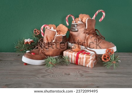 Saint Nicholas Day or Nikolaus, german holiday, December 6. Children shoes with traditional sweets. Royalty-Free Stock Photo #2372099495