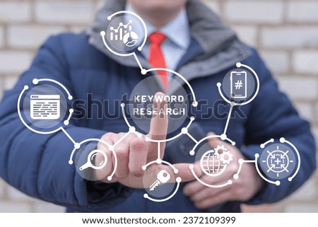 Man using virtual touch screen presses inscription: KEYWORD RESEARCH. Keyword Research and SEO optimization concept. Selection popular search terms with search engine suggestion tips. Keyword planner. Royalty-Free Stock Photo #2372109399