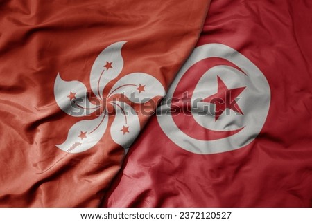 big waving realistic national colorful flag of hong kong and national flag of tunisia . macro