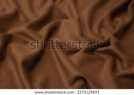 Close-up texture of natural beige fabric or cloth in brown color. Fabric texture of natural wool textile material. Beige canvas background. Royalty-Free Stock Photo #2372129691