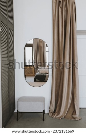 Elegant stylish wardrobe for clothes with closet, mirror, pouf, curtains. Interior decoration details. Modern aesthetic minimalist home bedroom interior design. Luxury apartment interior Royalty-Free Stock Photo #2372131669