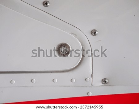 Detail of smalll airplane body. Ultralight plane or drone,  aluminum cover with rivets, the painted surface, Airplane airframe close-up Royalty-Free Stock Photo #2372145955
