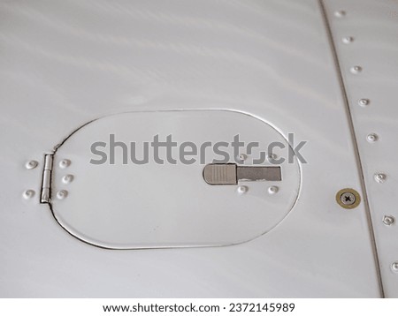 Detail of smalll airplane body. Ultralight plane or drone,  aluminum cover with rivets, the painted surface, Airplane airframe close-up Royalty-Free Stock Photo #2372145989