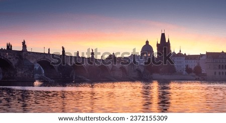 Charles Bridge (Czech Karlův most) is a 14th-century historical bridge over the Vltava River in Prague that connects the Old Town with the Lesser Town. It is the oldest stone bridge over the Vltava. Royalty-Free Stock Photo #2372155309