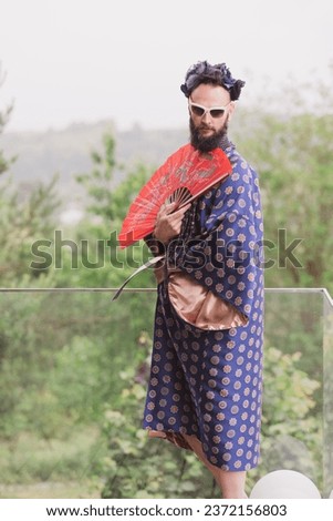 Young man wearing bathrobe night suit posing outdoor
