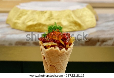  A photo of a waffle cone filled with Japanese food. The waffle cone is golden brown and crispy.