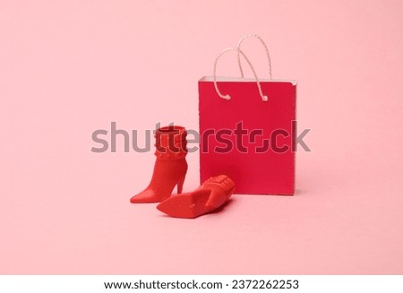 Shopping bag with doll boots on a pink background.Shopping, sale concept