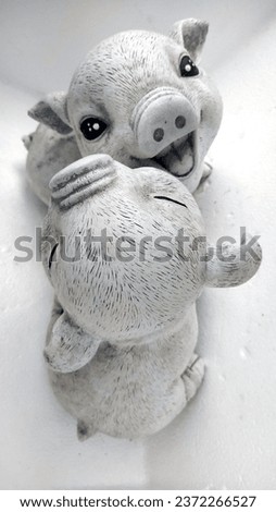 cute piglet statue Made from white plaster. 
Popularly used to decorate gardens and other places.