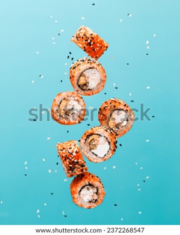 food photography of flying sushi rolls with salmon. Creative levitation concept  Royalty-Free Stock Photo #2372268547