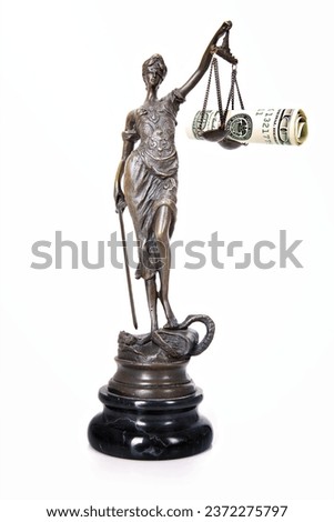 A picture of a Themis statue with dollar notes on the scale as a symbol of corruption over white background