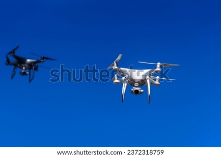 Drone flying in the sky. Aircraft innovation copter concept. Royalty-Free Stock Photo #2372318759