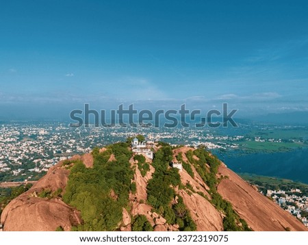 drone shot aerial view top angle panoramic photograph of hill cliff mountain rugged trekking trail hiking forest hilly rugged terrain landscape tourism hindu temple madurai india thirupuramkundram 