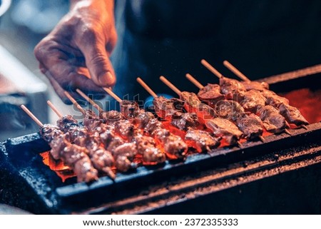 Yakitori Barbeque (BBQ) being grilled by street food store in Shinjuku, Tokyo, Japan. Royalty-Free Stock Photo #2372335333
