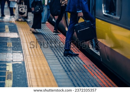 Close up people feet walking over the gap between a metro train and platform. People can fall into this gap and get injured Royalty-Free Stock Photo #2372335357