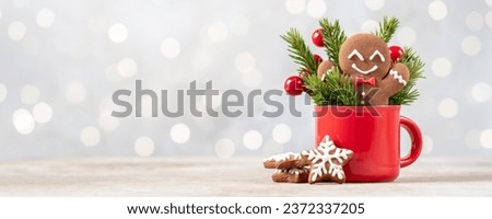 Christmas gingerbread man cookie in red cup. Christmas card Royalty-Free Stock Photo #2372337205