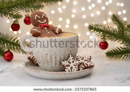 Gingerbread cookie man with a hot chocolate for Christmas. Traditional holiday symbol. Christmas holiday background.