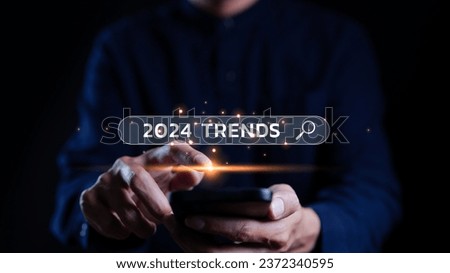 Trends 2024 year concept. Businessman showing search engine bar with 2024 trends wording for marketing monitor and business planning in new year. Finding information and new ideas for doing business. Royalty-Free Stock Photo #2372340595
