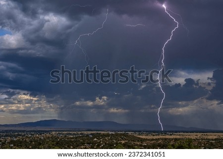 Lightning storm over Chino Valley Arizona during the 2023 Monsoon season. In the background is Mingus Mountain. This lightning strike was captured with a new Lightning Detector connected to the camera Royalty-Free Stock Photo #2372341051