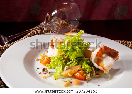Shrimp with Octopus in the Leaves of Green Salad with Cherry Tomatoes and Fresh Herbs. Photo, picture