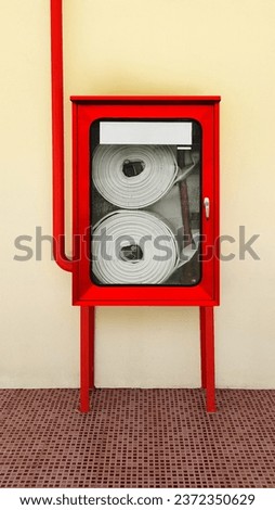 Fire extinguishing system on background wall, powerful emergency equipment for industry