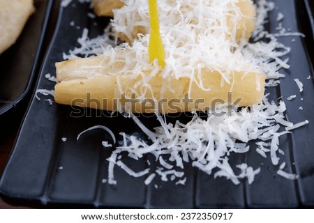 Cassava and cheese, snacks on the table, one portion of snack, fried cassava with grated cheese on top, it tastes savory of cheese and sweet of milk, delicious, ketela goreng keju, toping keju gurih