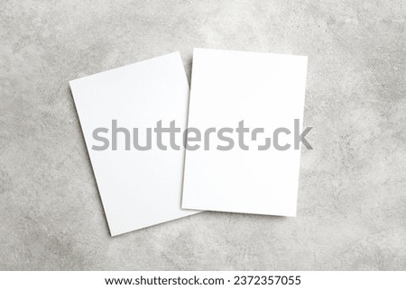 Two paper invitation cards on trendy grey background with copy space for card design presentation Royalty-Free Stock Photo #2372357055