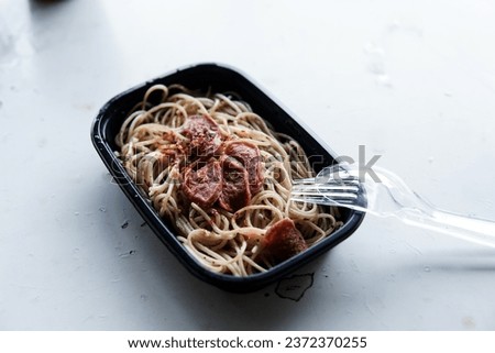 Frozen Spaghetti with sausage topping from mini market,Warm in microwave before serving isolated white background