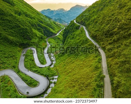Top view of Tham Ma mountain pass in Ha Giang province, north of Vietnam. A famous tourist destination of Ha Giang province. Curvy road on Ha Giang Loop Motorbike tour Royalty-Free Stock Photo #2372373497