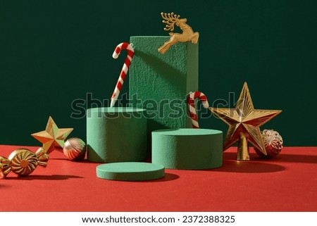 Christmas decoration concept with golden accessory and empty podiums displayed on green background. Scene for advertising with blank space for presentation products. Front view