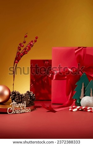 Large gift boxes in red color arranged with christmas trees, candy cane on the yellow background. Different types of decorations developed across the Christian world