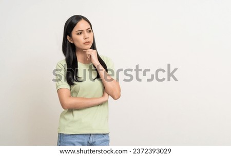 Upset confused bad emotional and thinking asian woman. Unhappy stressed female. Young latin lady standing feeling depressed dramatic scene looking copy space on isolated background.