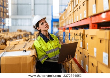 Portrait engineer woman shipping order detail check goods and supplies on shelves with goods background inventory in factory warehouse.logistic industry and business export