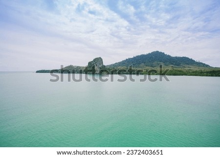 Sea water clings to the ground and the trees are beautiful on a clear sky day. Suitable for traveling and relaxing, swimming or making a background to promote a tourism page.