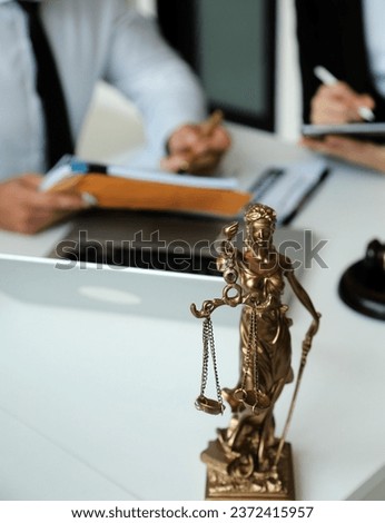 Judge gavel with Justice lawyers having team meeting at law firm in background. Concepts of law.