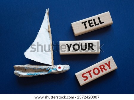 Tell your story symbol. Wooden blocks with words Tell your story. Beautiful deep blue background with boat. Business and Tell your story concept. Copy space.