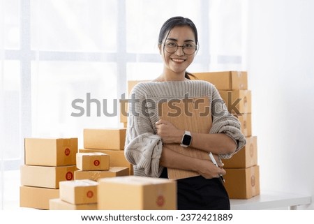 Starting Small business entrepreneur freelance, Portrait young woman working at home office, BOX, smartphone, laptop, online, marketing, packaging, delivery, b2b, SME, e-commerce concept.
