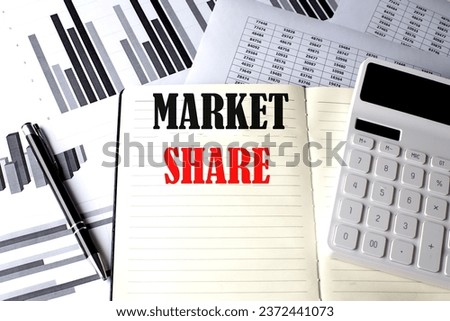 MARKET SHARE text written on notebook on chart and diagram