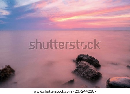 Sunrise in Denmark Ringkøbing Fjord. Longtime Exposure with beautiful colors in the morning an smooth water, dramatic sky. Royalty-Free Stock Photo #2372442107