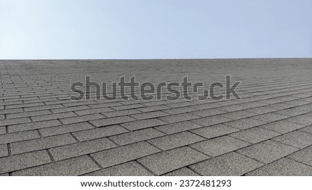 light steel shingle roof house, covered with rocks under the blue sky Royalty-Free Stock Photo #2372481293
