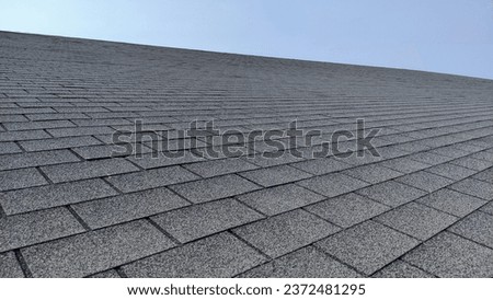 light steel shingle roof house, covered with rocks under the blue sky Royalty-Free Stock Photo #2372481295