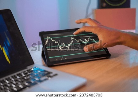 Cropped photo of an unrecognizable businessman checking stock market data in a digital tablet