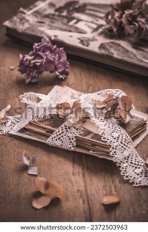 Memories, antique and old family photos with  dried flowers in vintage style on wooden table