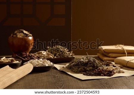 Brown background with vintage window frame for product advertising. Traditional medicines are stored on wooden trays, decorated with medicinal herbs wrapped in paper on wooden tables. Royalty-Free Stock Photo #2372504593