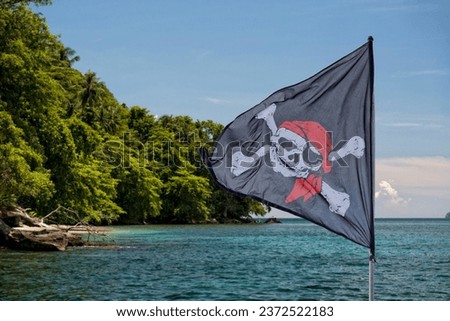 waving pirate flag jolly roger on sky background