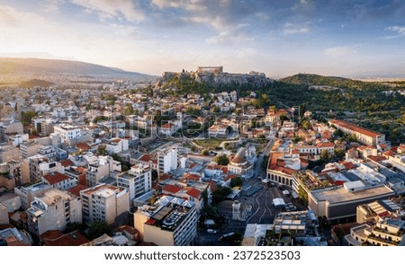 Panoramic view of the old town of Athens with Monastiraki square and the Parthenon Temple of the Acropolis during a golden sunrise