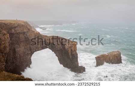 The Green bridge of Wales on the Pembrokeshire coast UK during storm Agnes Royalty-Free Stock Photo #2372529215