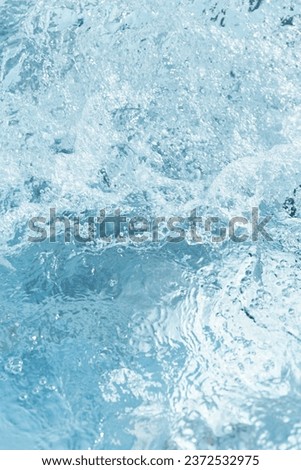 blue water surface with waves and bubbles. minimalistic fresh summer background for invitation or banner