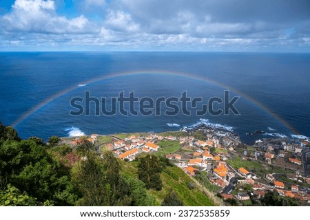 Rainbow over a small town in Madeira