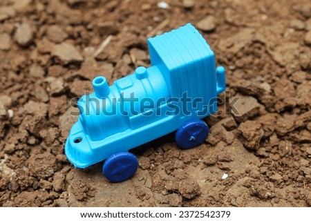 Blue children's toy train on the ground.  children.  toy train